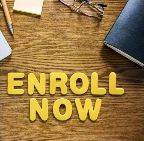 Wooden letters spelling Enroll now on a desk